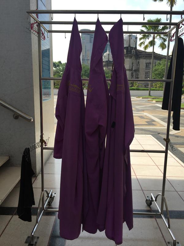 Áo choàng tím và nón trùm đầu màu đen dành cho du khách nữ